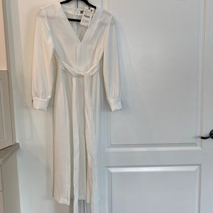 Beautiful midi white dress with front slit.